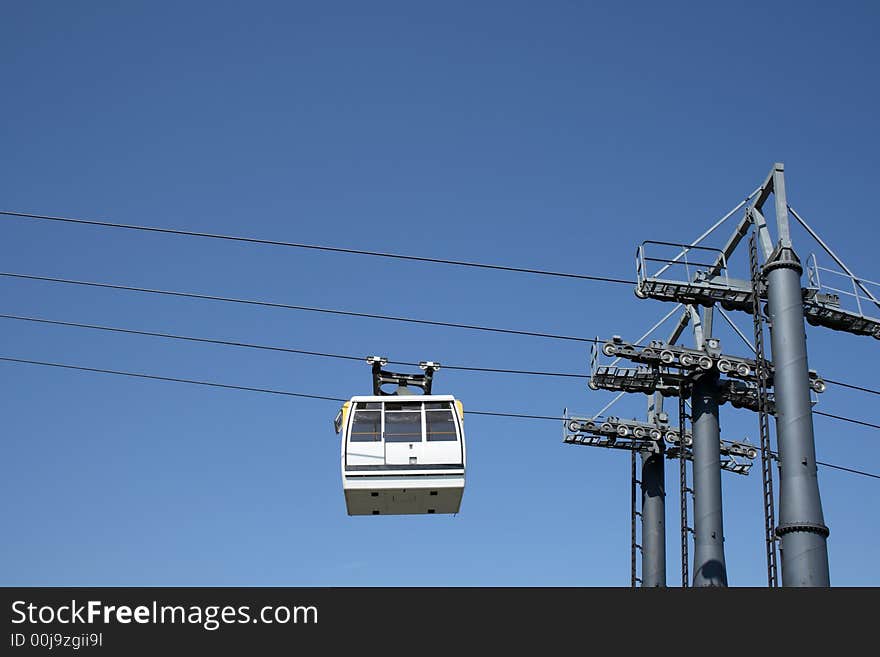 White cable car going up to the mountain.