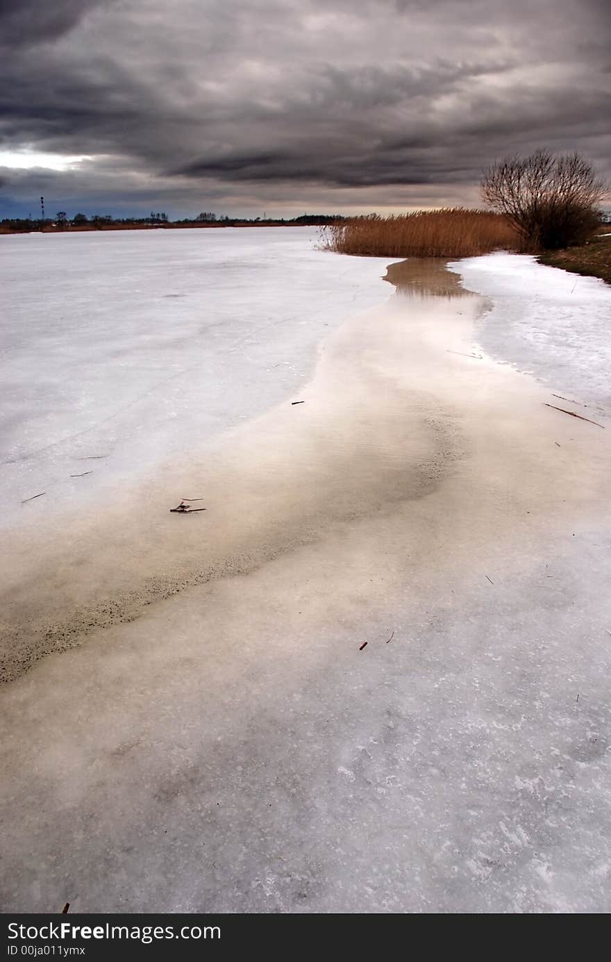 Storm clouds over a frozen lake