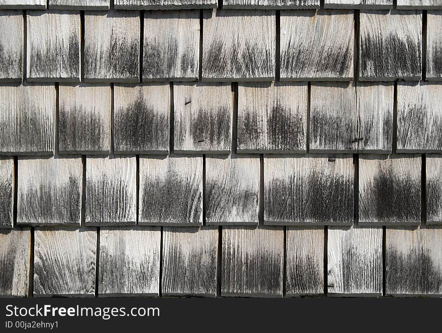 Wooden tiles pattern. Detail of an old house wall.