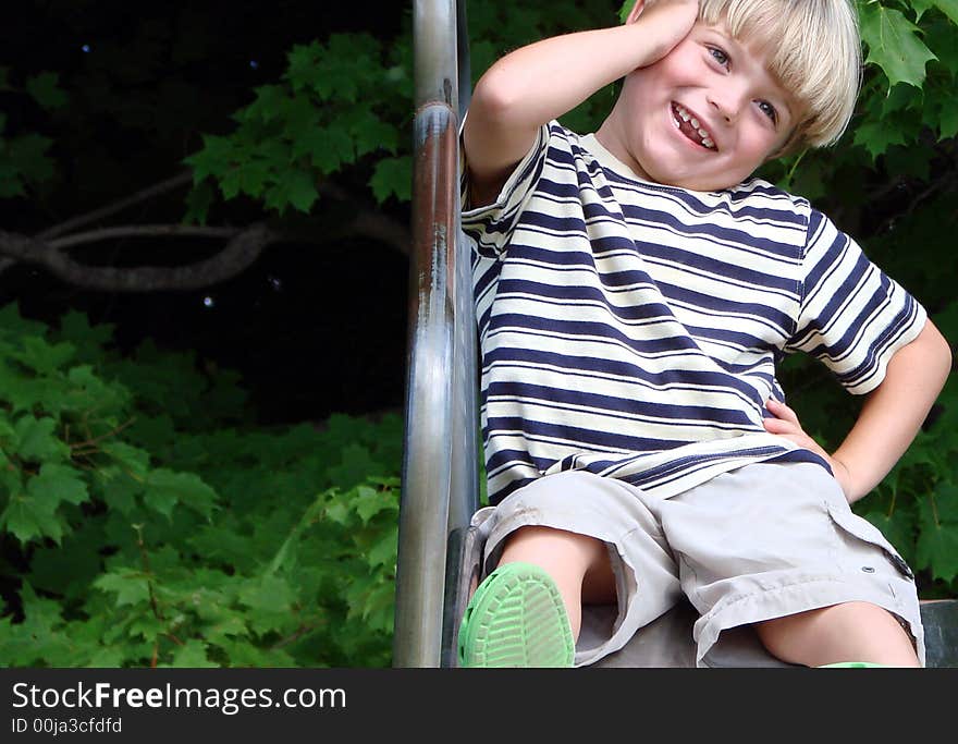 A young boy smiles while playing. A young boy smiles while playing