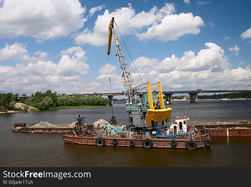 Hydraulic dredge on barge in the working river