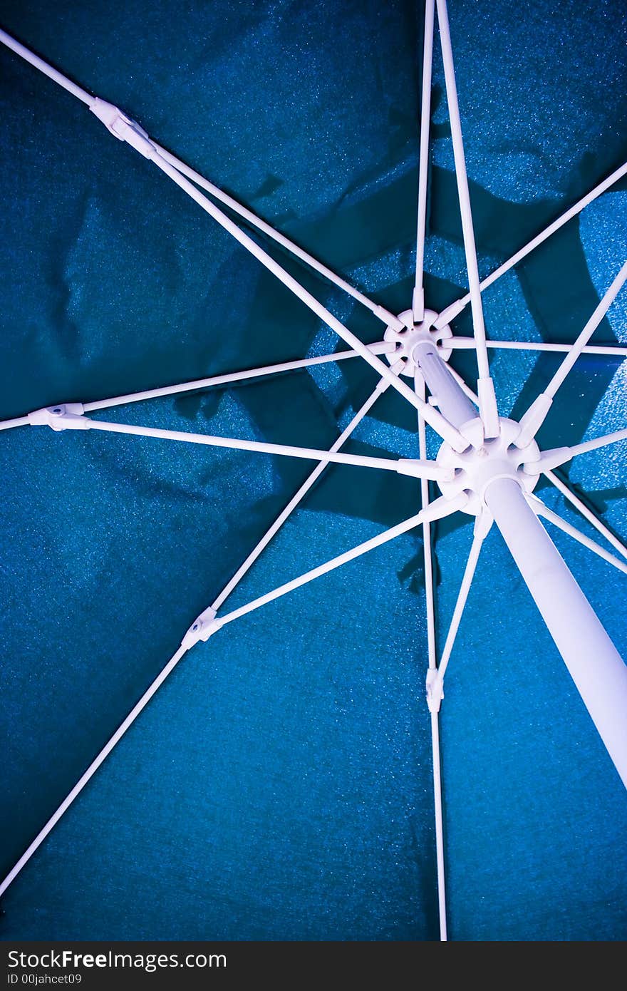 The underside of an umbrella during mid day sun