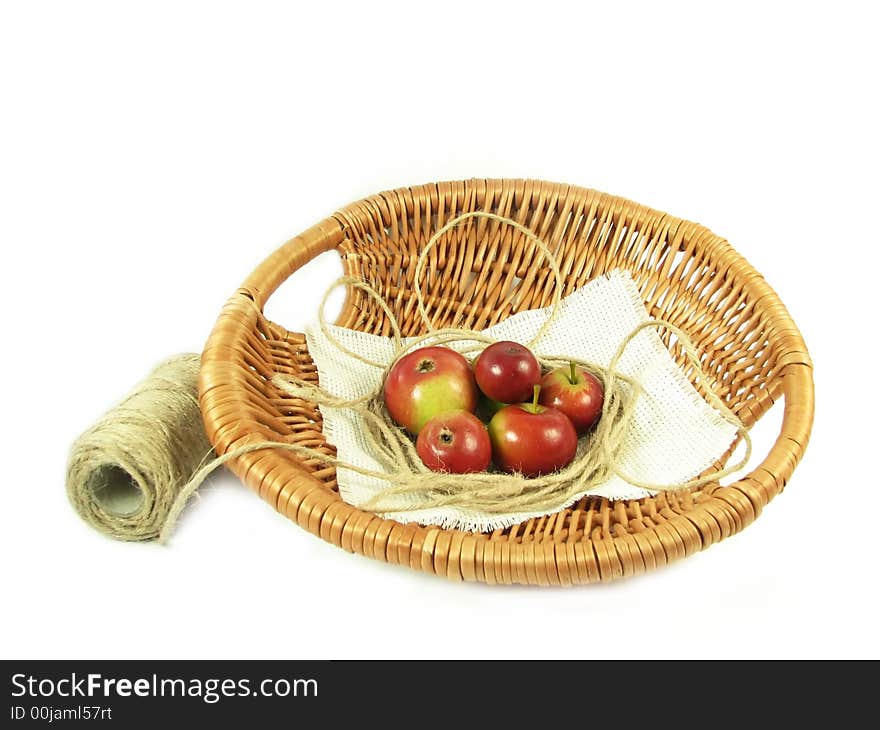 Nature, composition: red apple in basket and string on white background