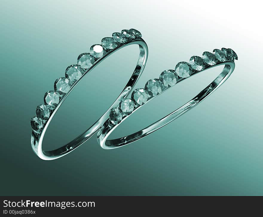 Two rings with diamonds against a green background