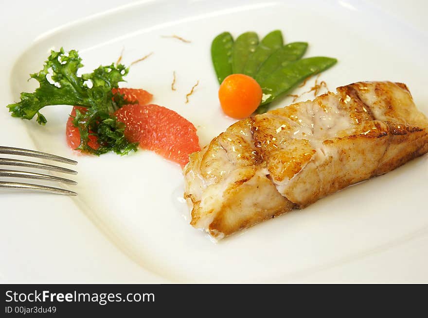 Slice of a grilled salmon with vegetables