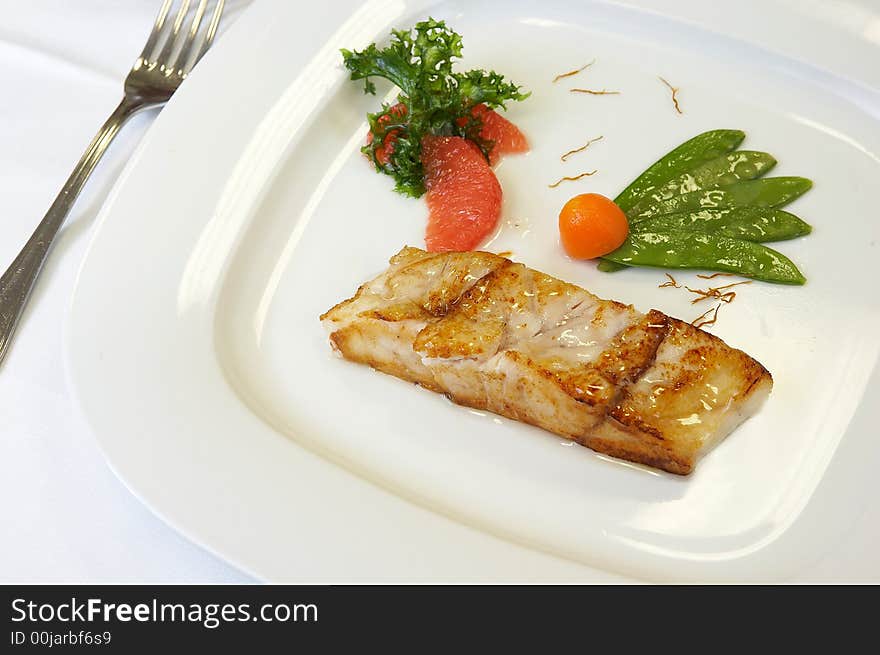 Slice of a grilled salmon with vegetables