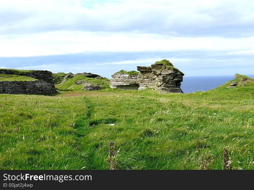 Layers of sedimentary rock eroded away to form this stack high above the North Atlantic Ocean. Layers of sedimentary rock eroded away to form this stack high above the North Atlantic Ocean