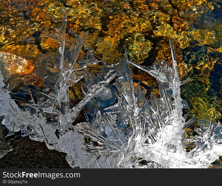 A close up of the fancy melting ice abobe the flowing water. A close up of the fancy melting ice abobe the flowing water.