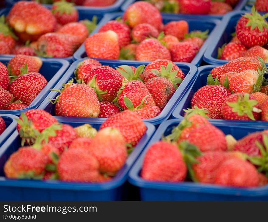 Red strawberries in plastic boxes.