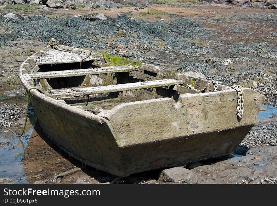 An old fishing boat abandoned in a mudbank. An old fishing boat abandoned in a mudbank