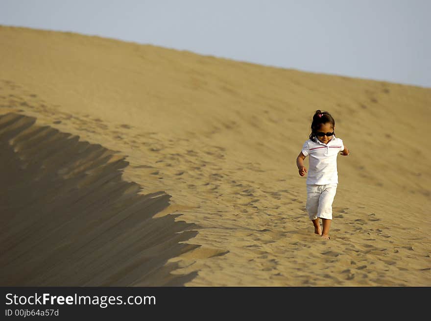 A child is walking alone in the desert. A child is walking alone in the desert