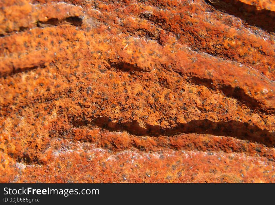 Close up of a rusty plaque with deep wrinkles