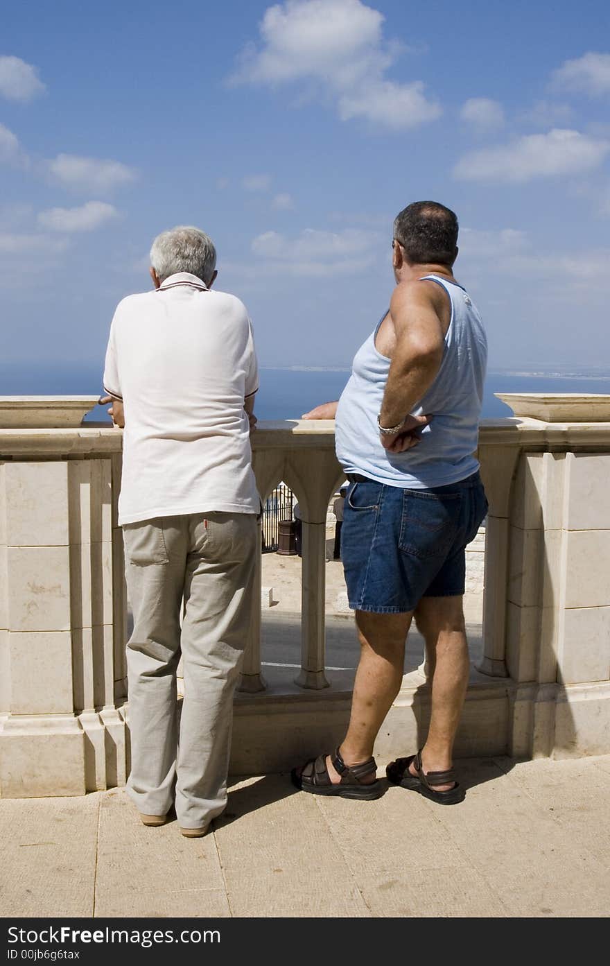 Two men standing by the shore of the ocean. Two men standing by the shore of the ocean