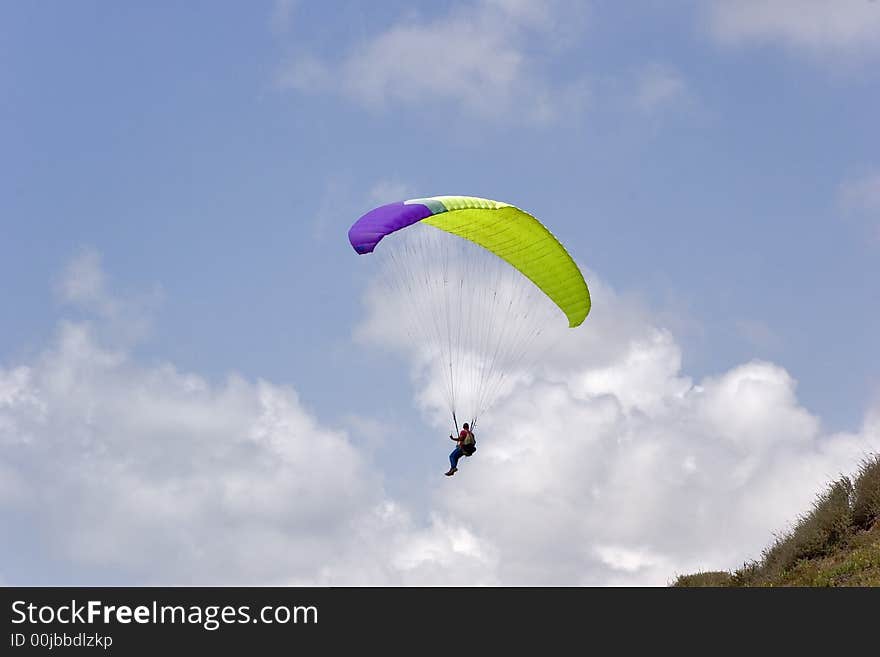 Flight on an operated parachute along coast of Mediterranean sea. Flight on an operated parachute along coast of Mediterranean sea