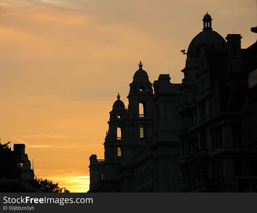 Palace with crowns against sunset, silhouette. Palace with crowns against sunset, silhouette