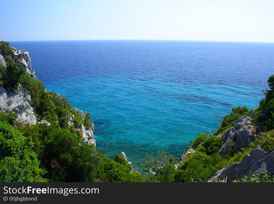 Coast with rocks, trees and blue sky