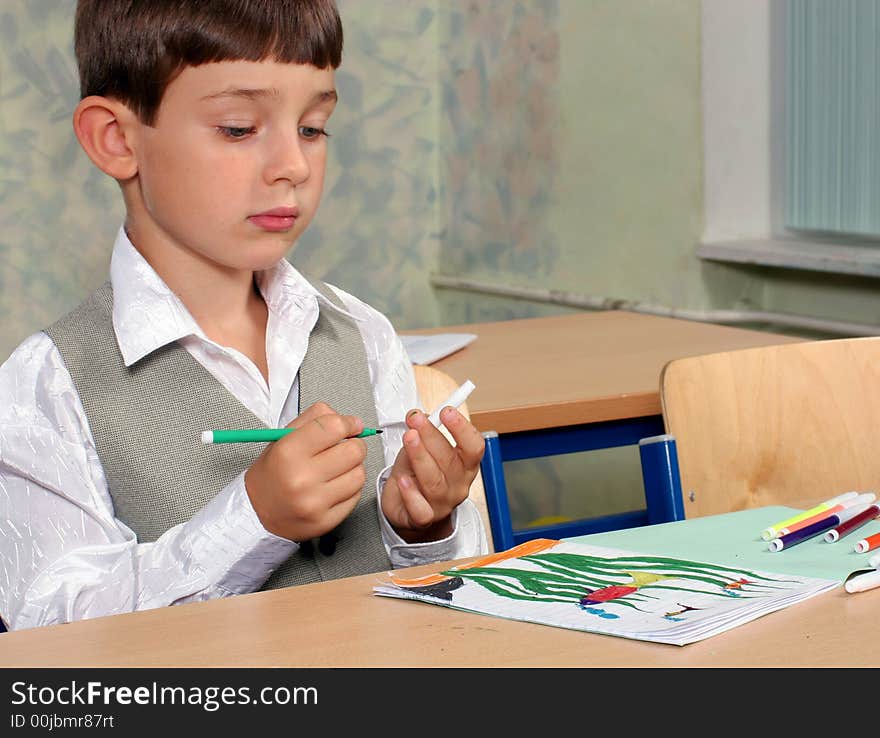 Portrait of the schoolboy with his picture. Portrait of the schoolboy with his picture