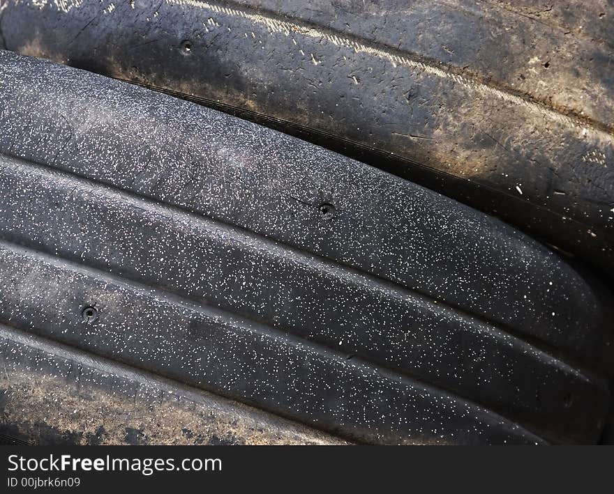 Worn tread on discarded racing tires.