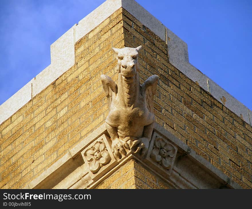 Gargoyle appears to be growing out of the corner of this old church. Gargoyle appears to be growing out of the corner of this old church