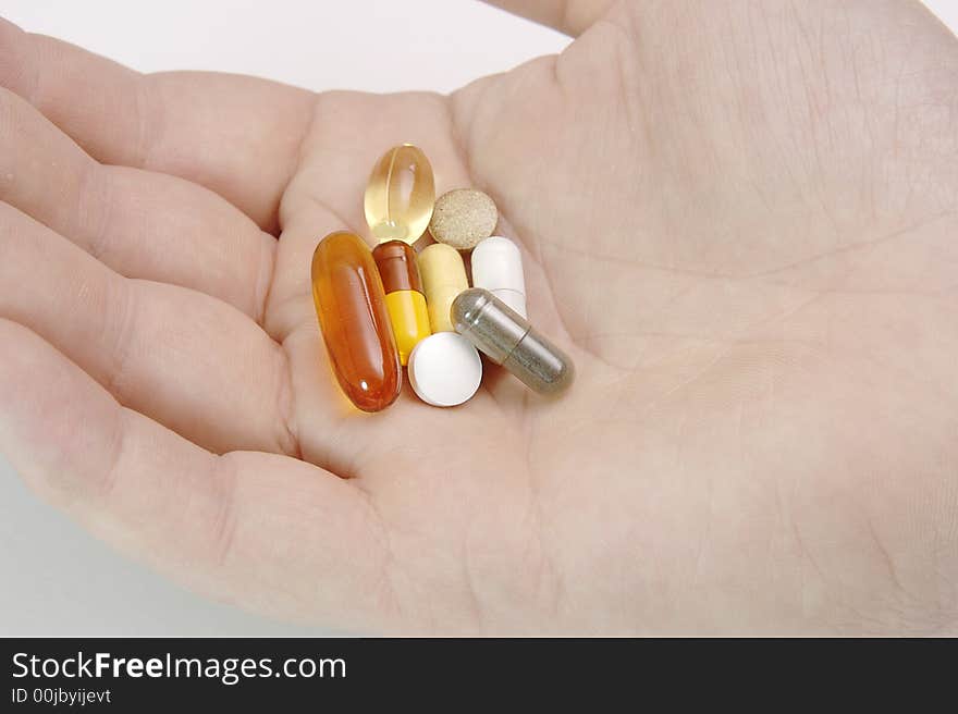 Male hand full of pills, vitamins and medicine. Male hand full of pills, vitamins and medicine