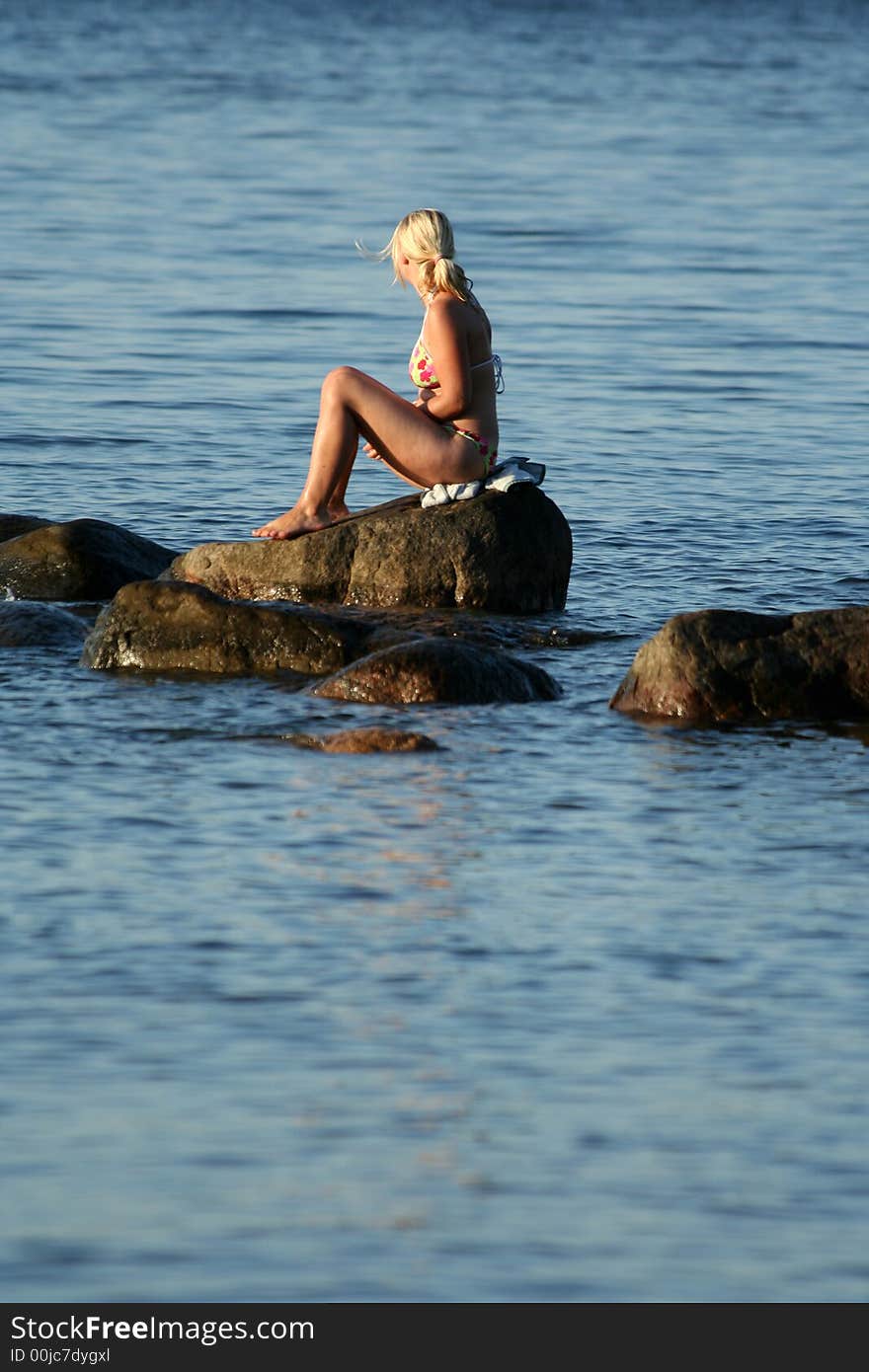 Girl sitting on the stone