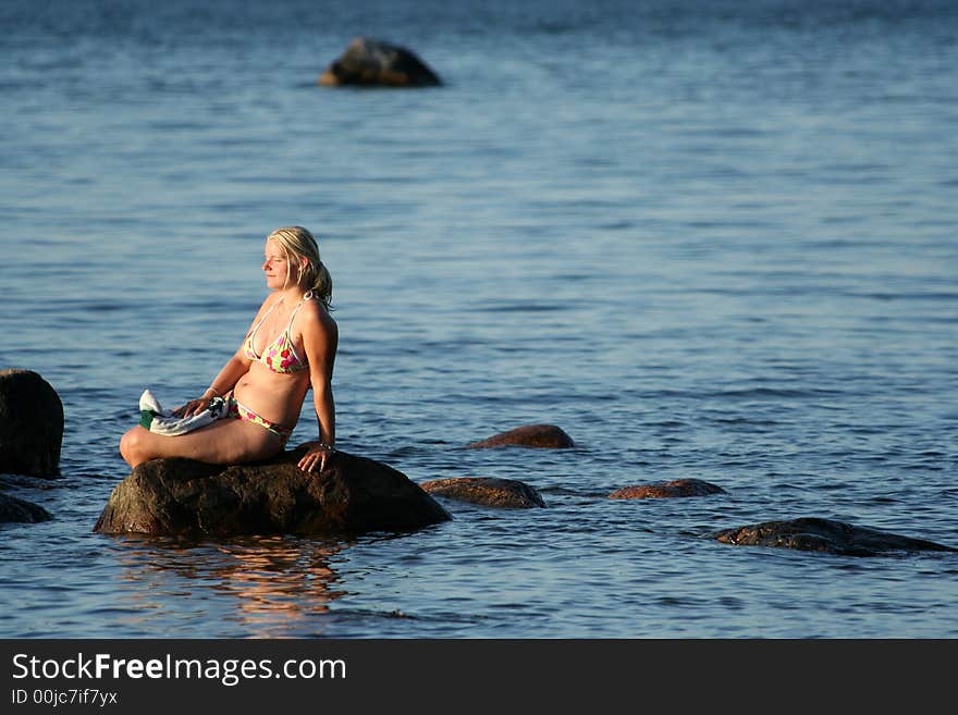 Girl sitting on the stone