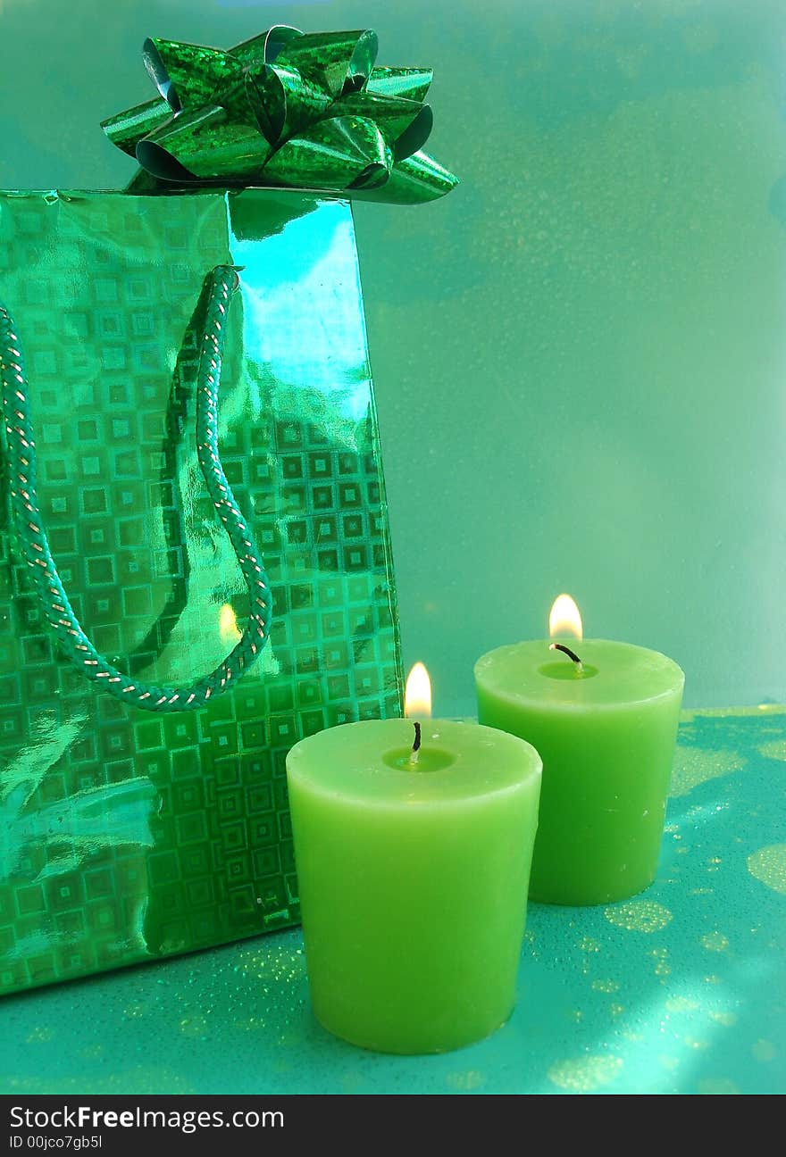 Green gift bag and candles