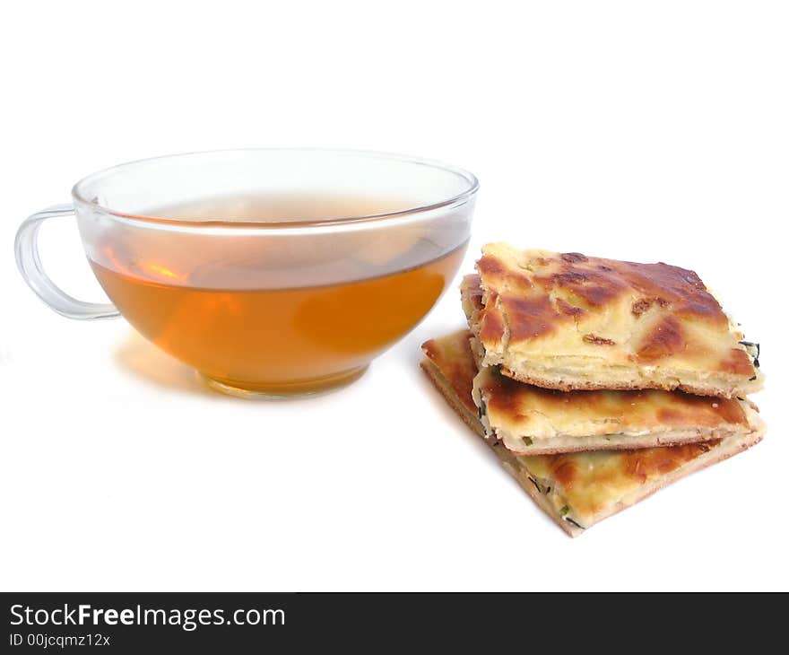 Tea cup with pie with cheese and parsley filling on white background