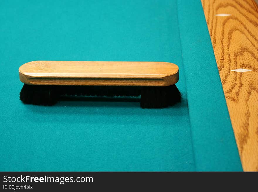 Pool table brush on a table