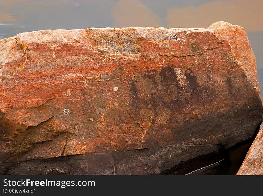 Big rocks laying in the water at the beach. Big rocks laying in the water at the beach