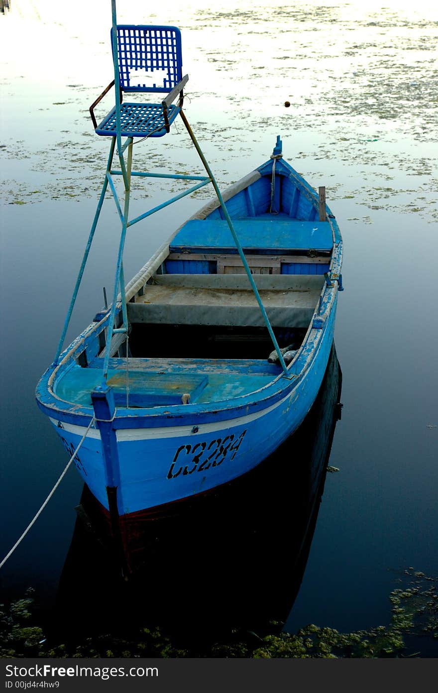 Blue and small fishing boat with a small deer-stand. Blue and small fishing boat with a small deer-stand.