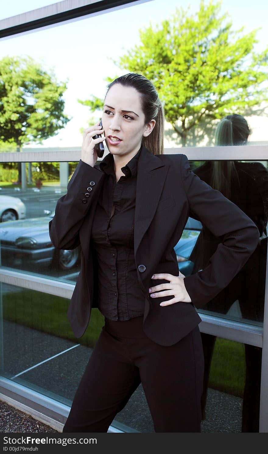 Business woman wide shot standing over large windows. Business woman wide shot standing over large windows