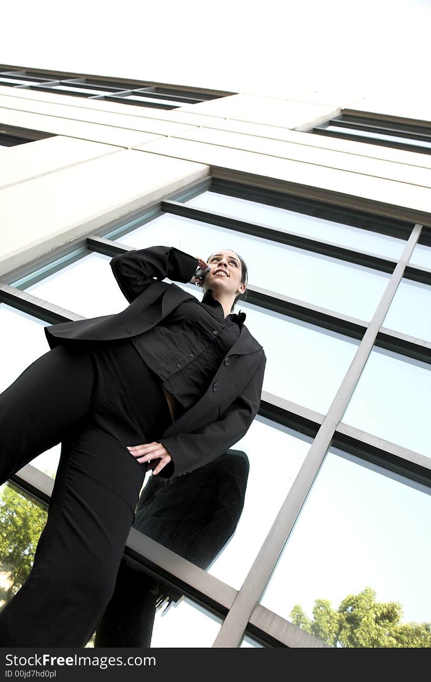 Business woman wide shot standing over large windows. Business woman wide shot standing over large windows