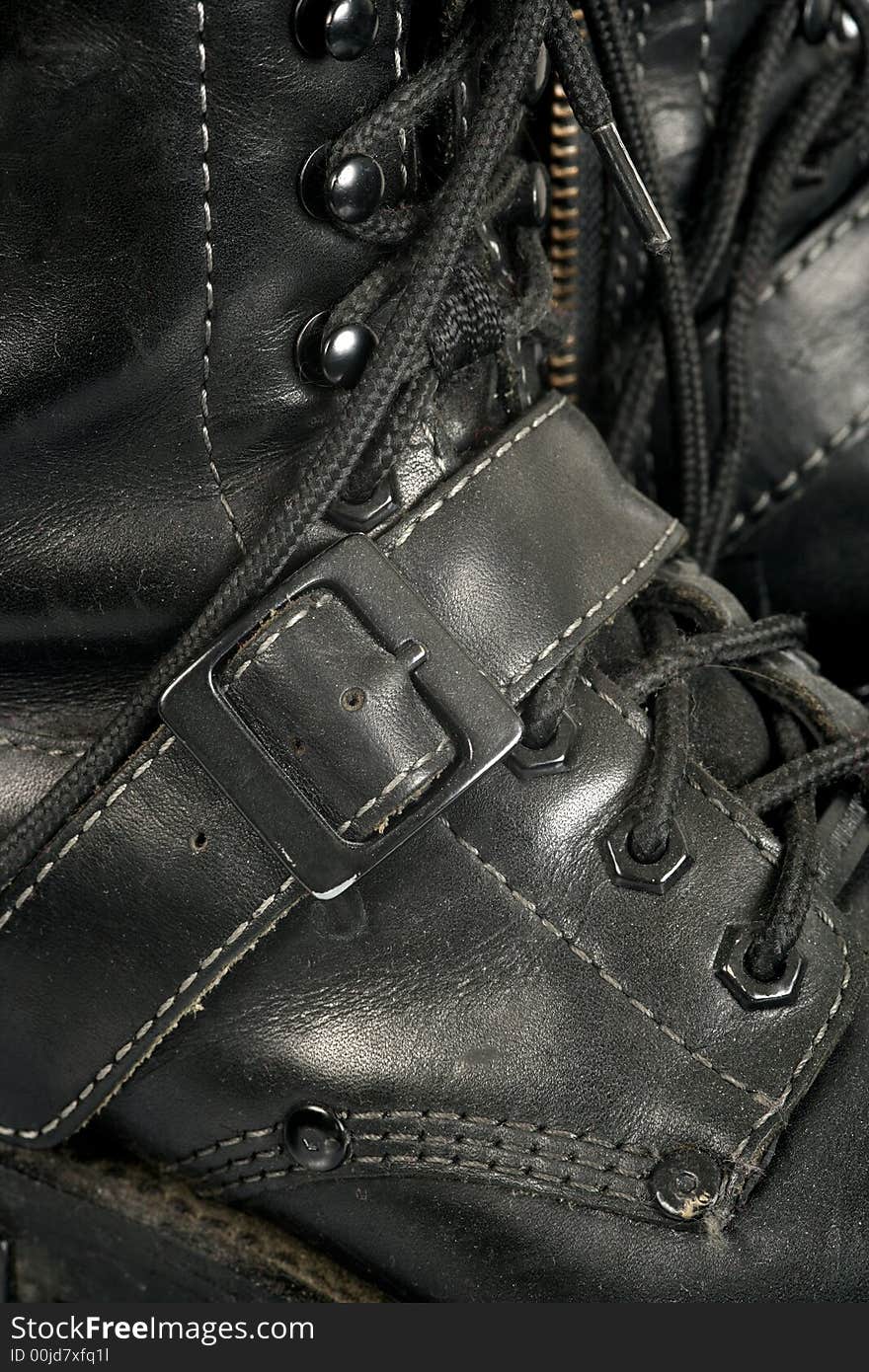 Background image of well worn, dirty, scuffed black boots. Background image of well worn, dirty, scuffed black boots.