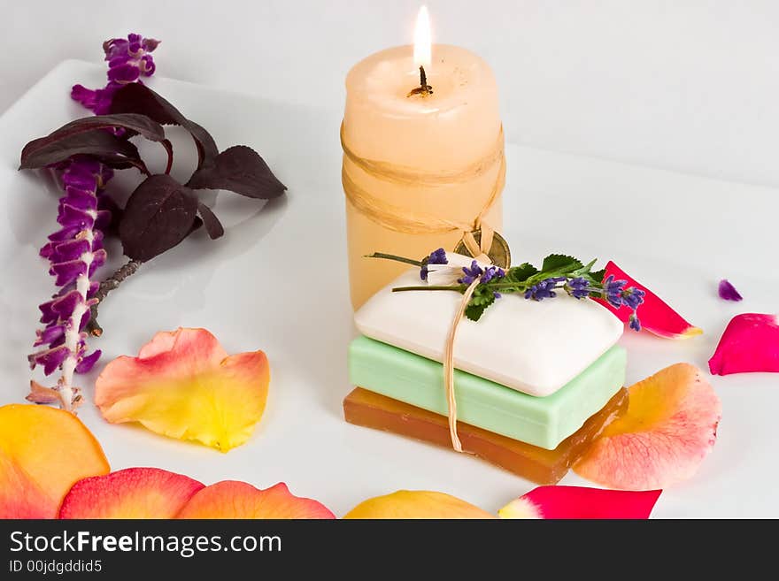 Soap bars and aromatic candle decorated with rose petals. Soap bars and aromatic candle decorated with rose petals