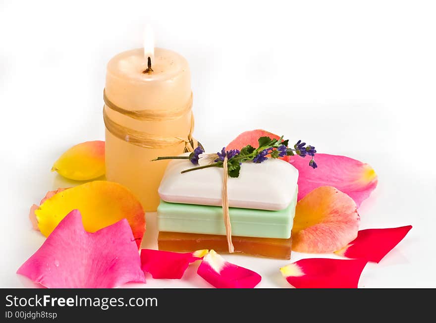 Soap bars and aromatic candle decorated with rose petals. Soap bars and aromatic candle decorated with rose petals