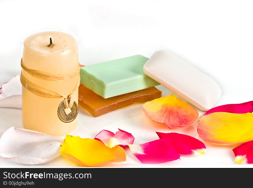 Soap bars and aromatic candle decorated with rose petals. Soap bars and aromatic candle decorated with rose petals