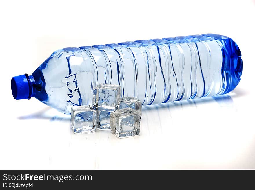 Bottle of mineral water and ice cubes