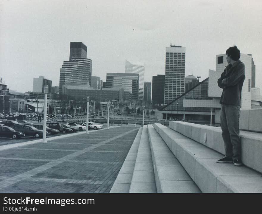 A guy standing , waiting on a friend. looking back at the town that shaped him. thinking, lonely. A guy standing , waiting on a friend. looking back at the town that shaped him. thinking, lonely.