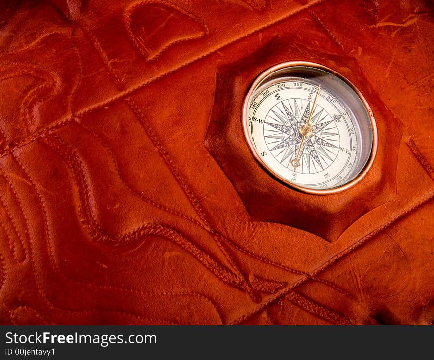 Vintage compass on the leather texture