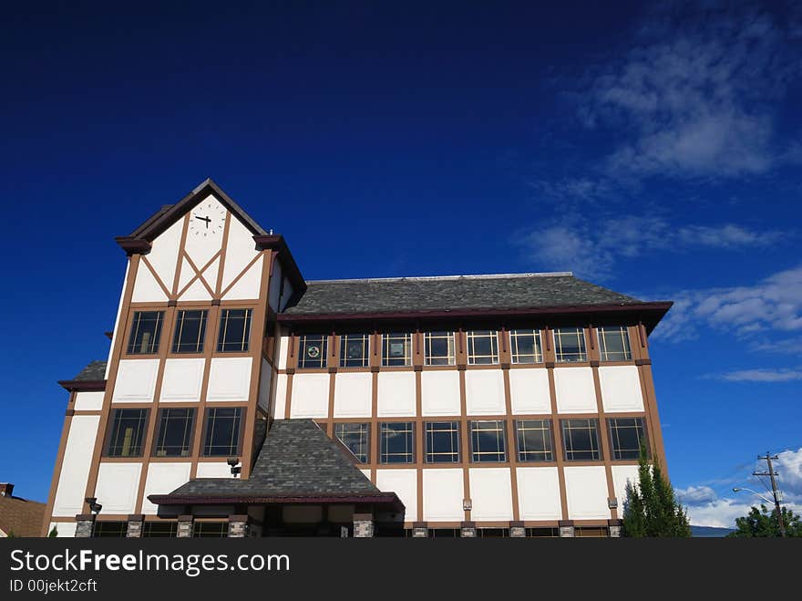 School building with clock, blue sky background