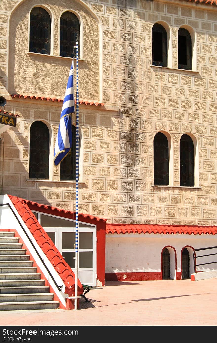 Orthodox church in Greece with a greek flag