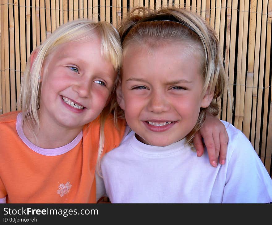 Brother and sister sitting and smilling. Brother and sister sitting and smilling.