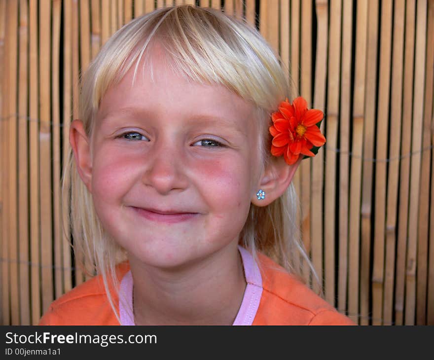 The child with a flower behind ear. The child with a flower behind ear.