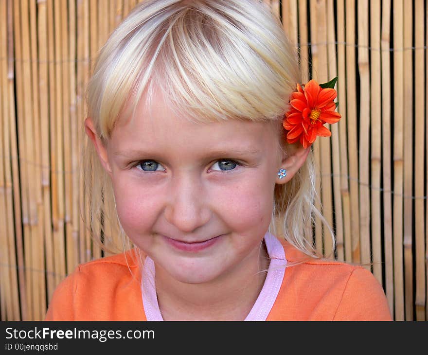 The child with a flower behind ear. The child with a flower behind ear.