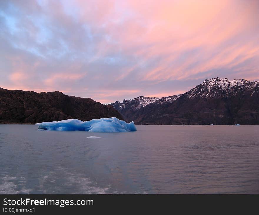 Floating iceberg in Argentina Lake at sunrise