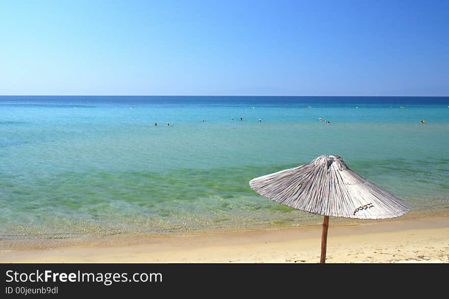 Beach with umbrellas in the morning in Greece