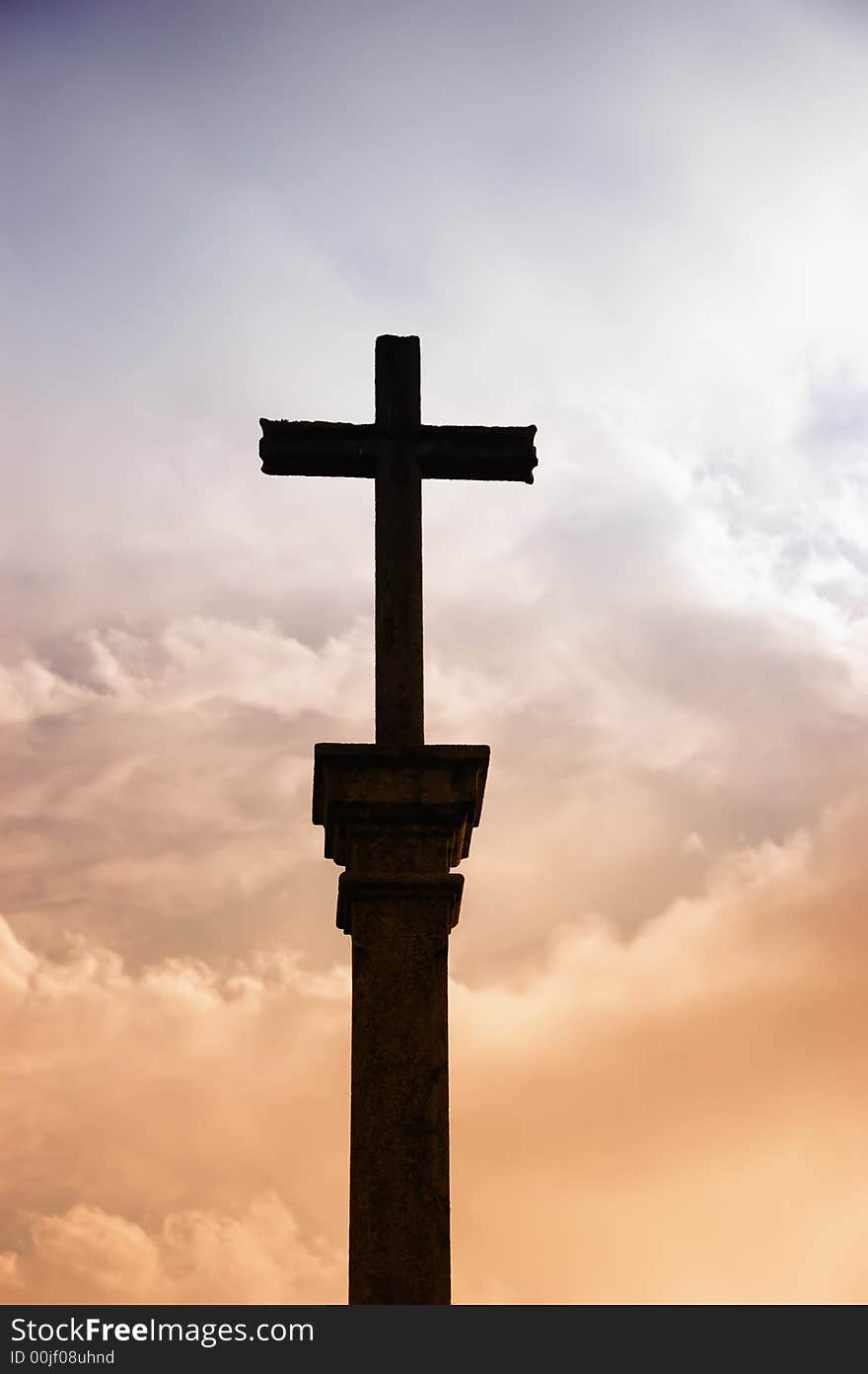 Cross silhouette and the clouds at sunset