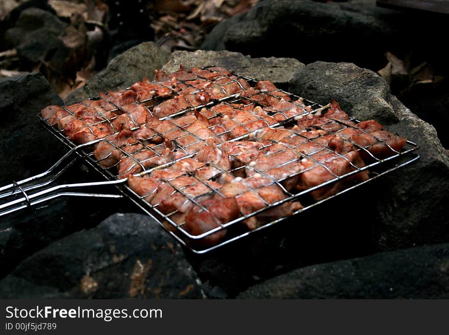 Meat roasted on open fire between stones. Meat roasted on open fire between stones