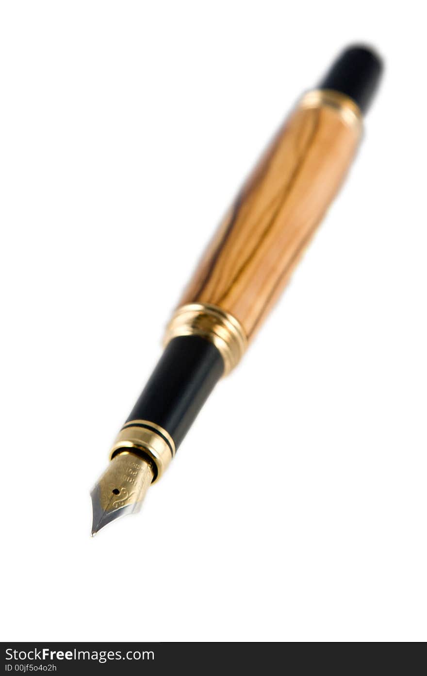 A handmade fountain pen displayed on white with a shallow depth of field (dof). The pen is made from Bethlehem Olive Wood. (The pen was handmade by the photographer in his studio). A handmade fountain pen displayed on white with a shallow depth of field (dof). The pen is made from Bethlehem Olive Wood. (The pen was handmade by the photographer in his studio).